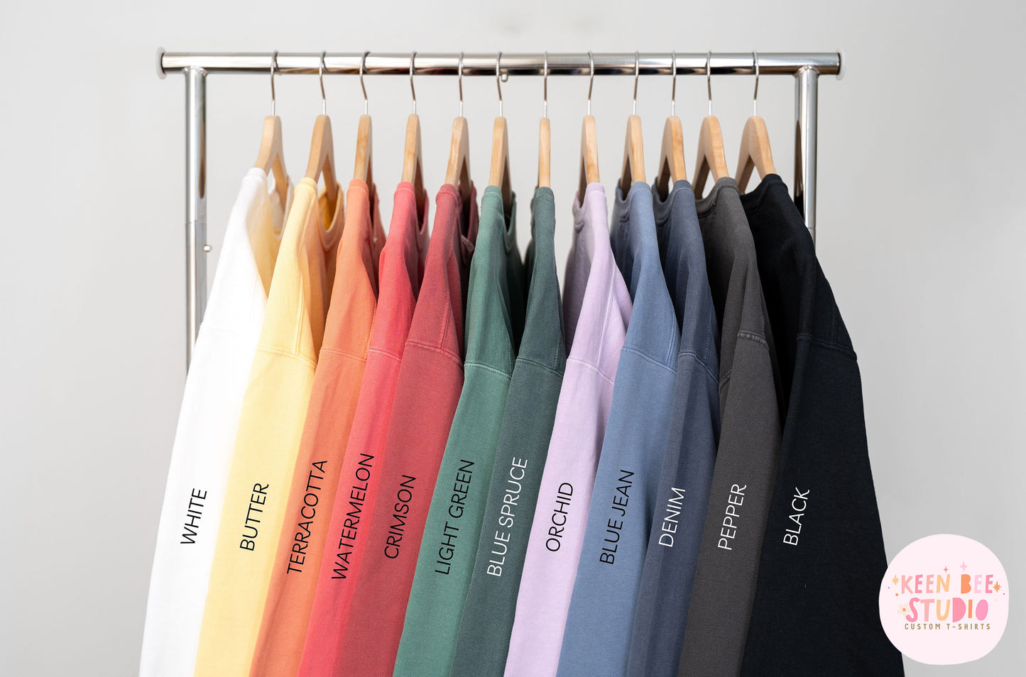 a rack with a variety of t - shirts hanging on it